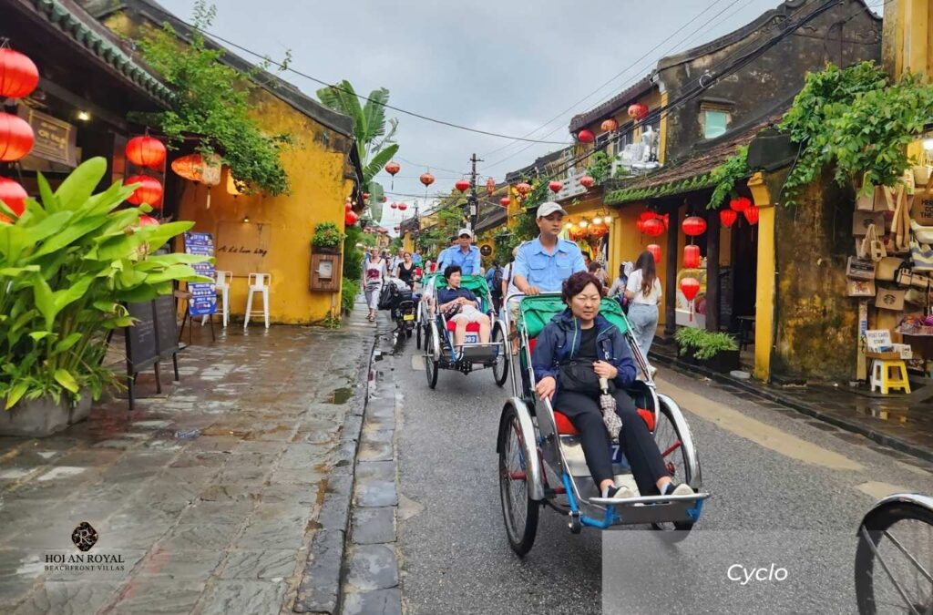 Tourists experience sitting in a cyclo and strolling around the ancient town of Hoi An