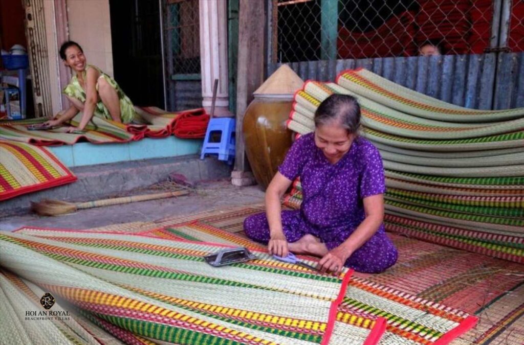 Close-up of an artisan weaving a mat in Ban Thach Mat-Weaving Village