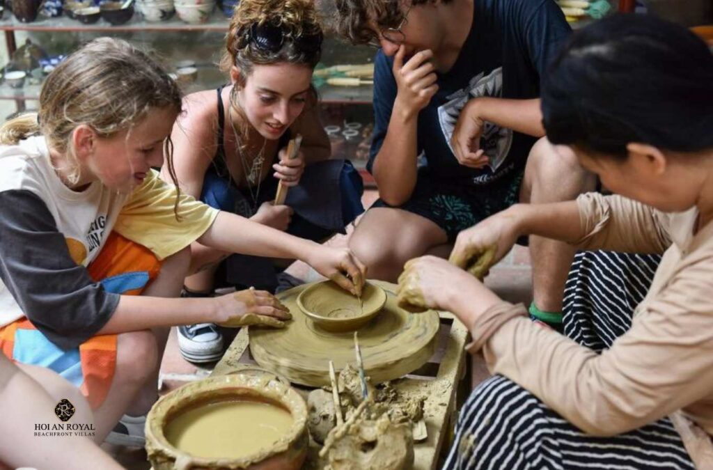 Visitors experiencing traditional pottery–making in the village